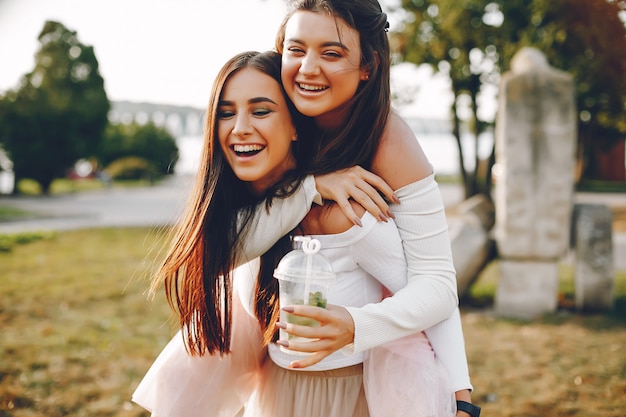 Free photo two pretty girls in a summer park