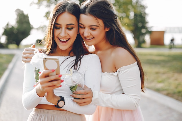 Two pretty girls in a summer park