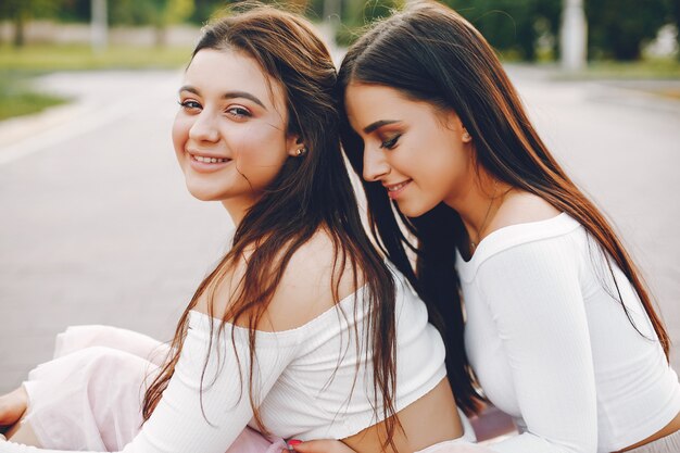 Two pretty girls in a summer park