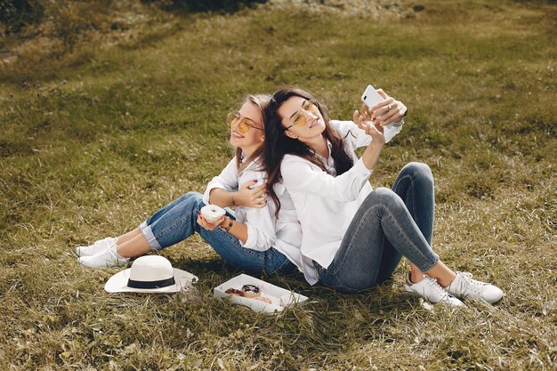Free Photo two pretty girls in a summer park  