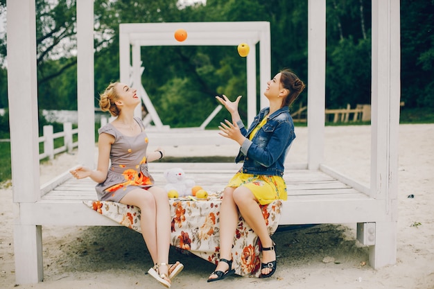 Two pretty girls in a summer park