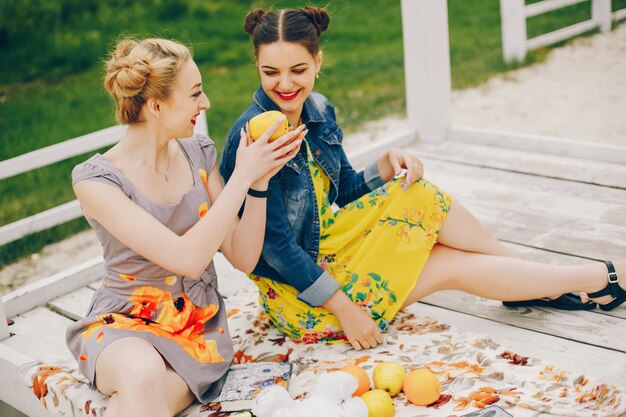 Two pretty girls in a summer park