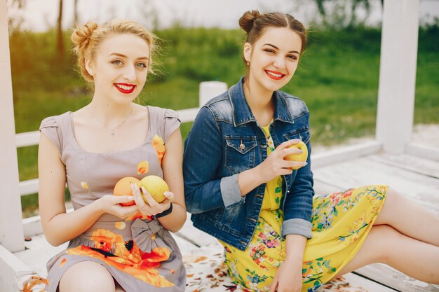 Two pretty girls in a summer park