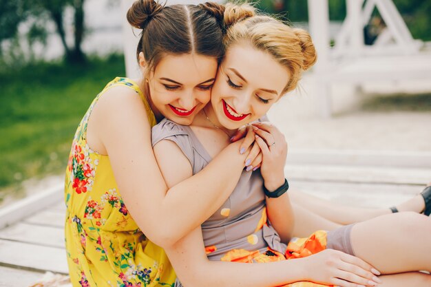 Two pretty girls in a summer park