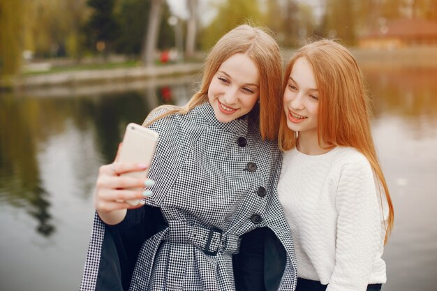 two pretty sisters in a park