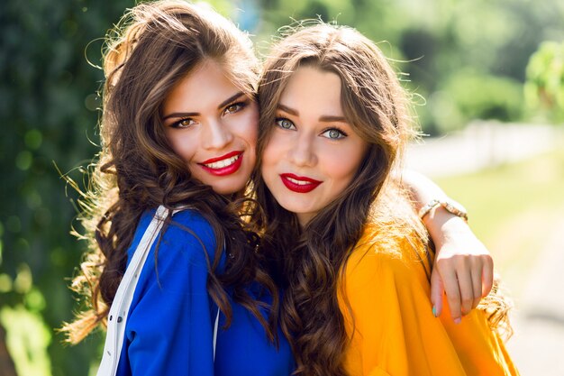 two pretty women hugging and smiling