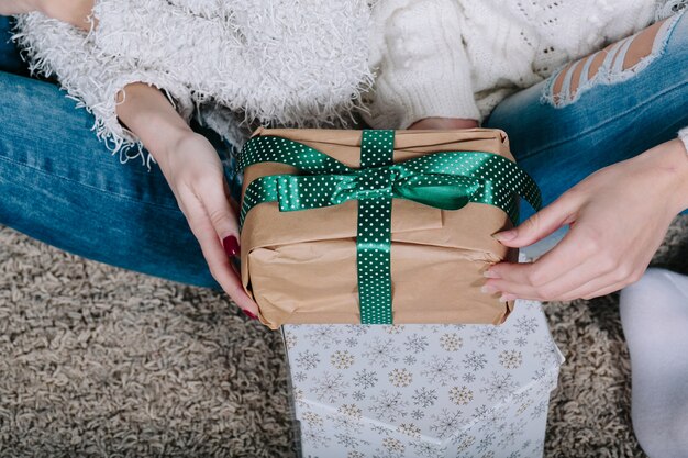 Two pretty women with gifts for Christmas, close view