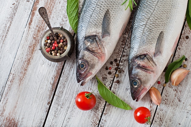 Two raw seabass with spices Free Photo