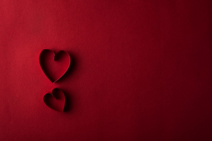 Free Photo two red hearts against red background