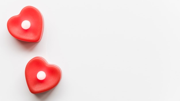 Two red hearts on table with copy-space