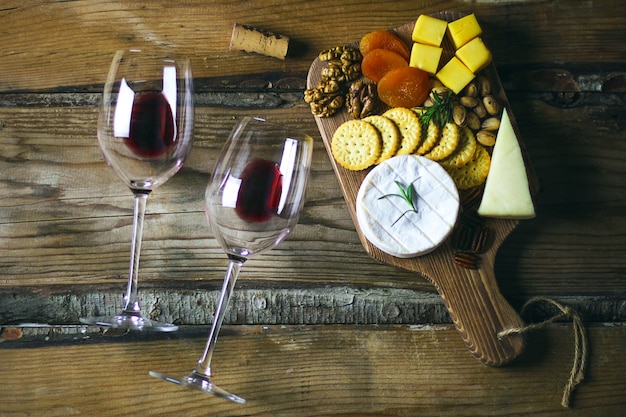 Two red wine glass and cheese platter top view