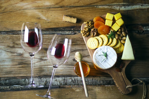 Two red wine glass and cheese platter top view