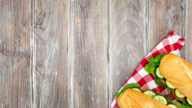 Two sandwiches on tablecloth with copy space