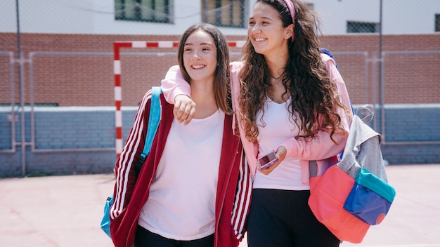 Two schoolgirls in schoolyard