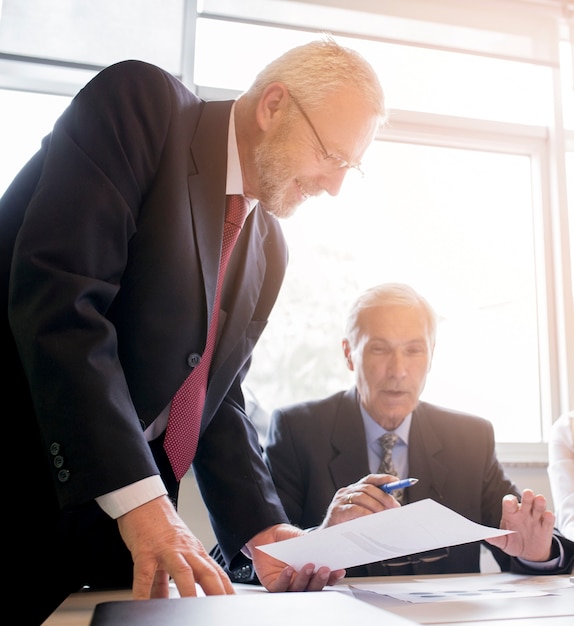 Two senior businessman discussing the document in the office