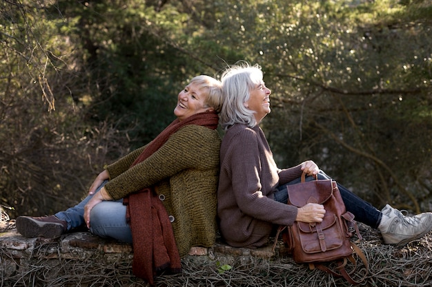 Two senior female friends enjoying a hike together in nature