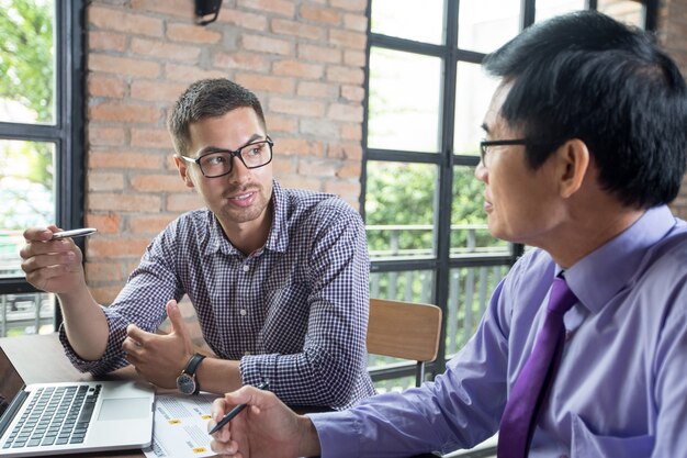 Two Serious Colleagues Talking in Loft Office