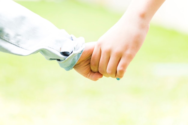 Two siblings holding hands