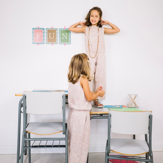 Two sisters having fun with table