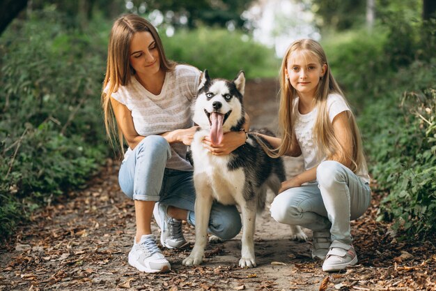 Two sisters with their dog in park