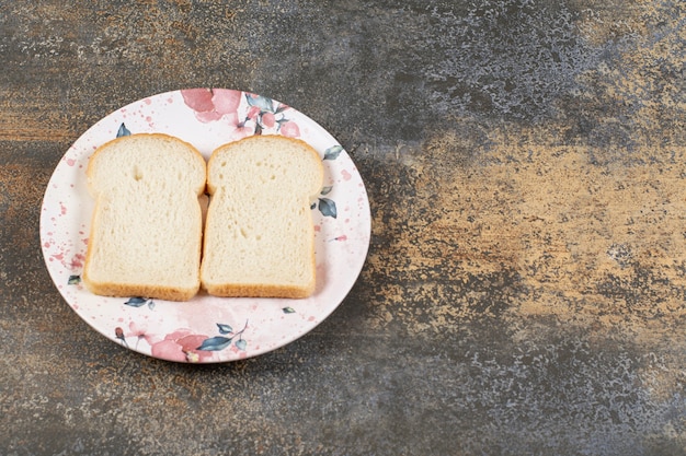 Free photo two slices of bread on colorful plate.