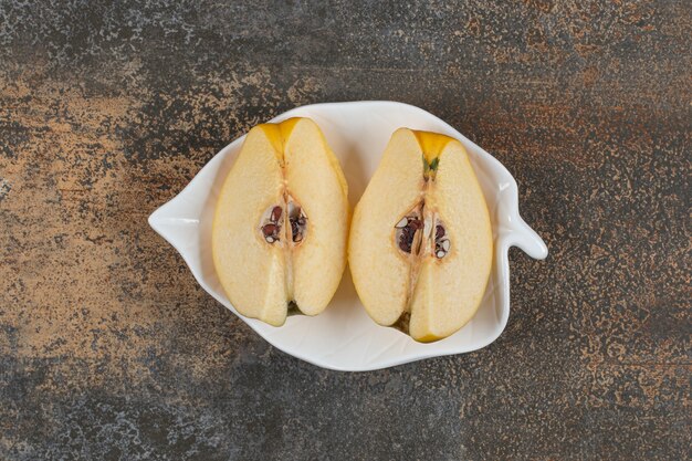 Two slices of quince on leaf shaped plate