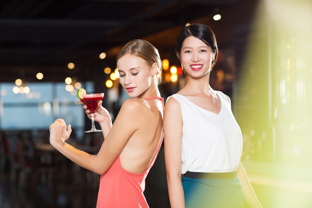 Two Smiling Young Women in Nightclub
