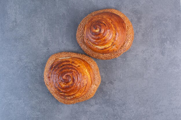 Two stacks of bagels with buns on marble background. High quality photo