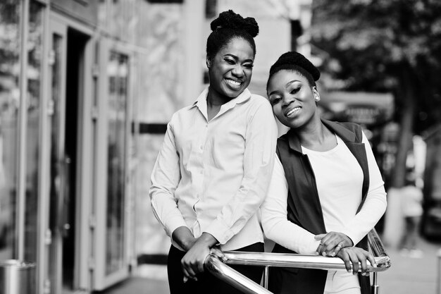 Two stylish african american girls friends posed outdoor of steets city