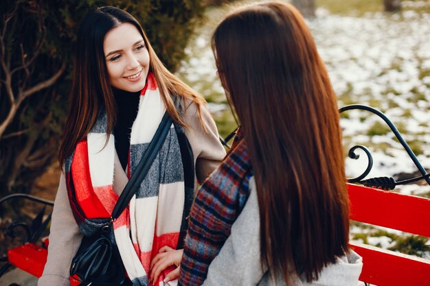 Two stylish girls have a rest in a city