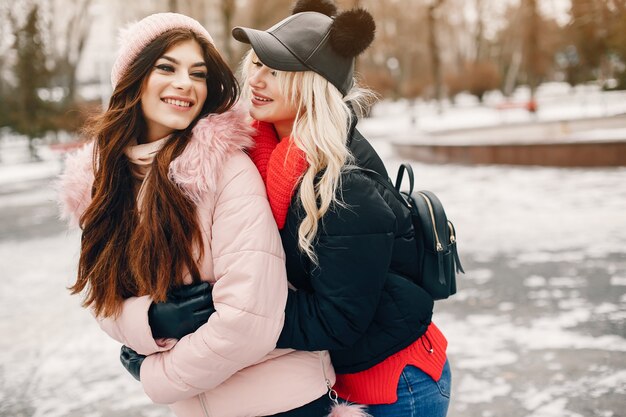 Two stylish girls have a rest in a city