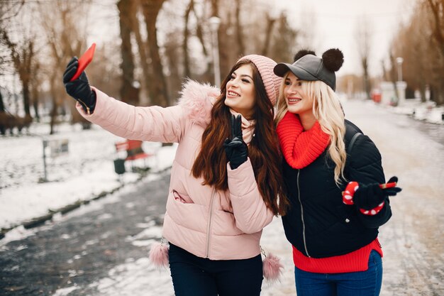 Two stylish girls have a rest in a city