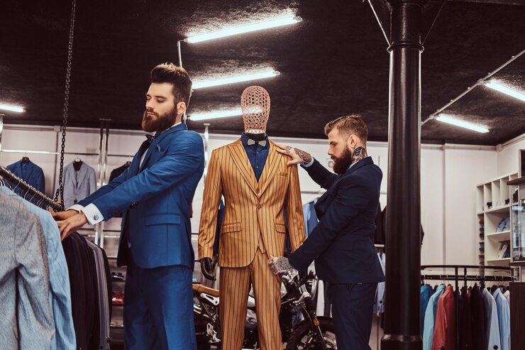 Free Photo two stylish shop assistants elegantly dressed working in a menswear store.