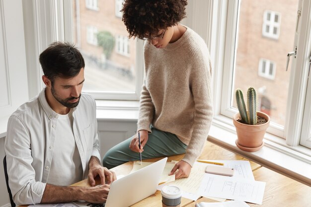 Two successful coworkers working at home