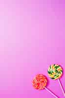 Free photo two sweet lollipops on pink background