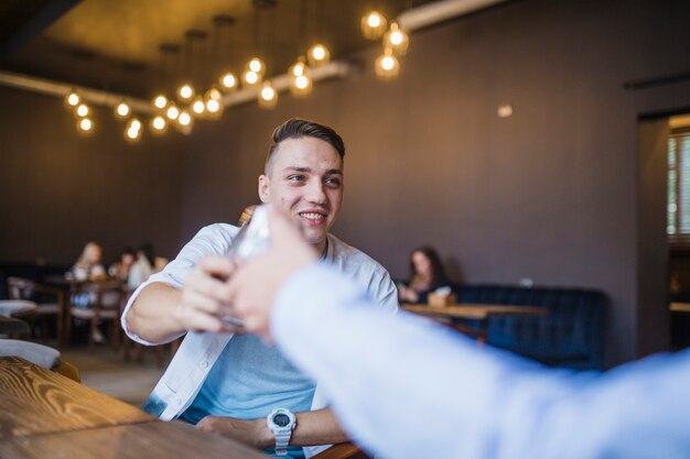 Two toasting drinks with his friends in the restaurant