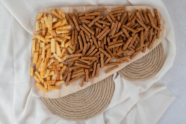 Two types of crackers on wooden board. 