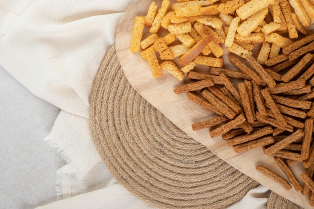 Two types of crunchy crackers on wooden board