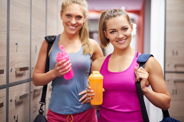 Two women in dressing room at gym