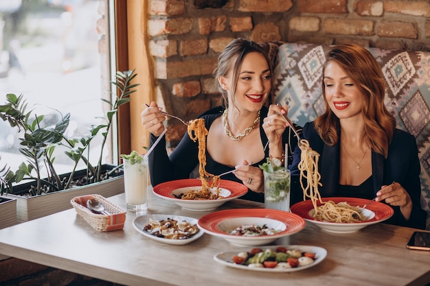 Due donne che mangiano pasta in un ristorante italiano