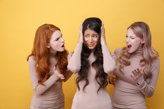 Free photo two women screaming on their friend