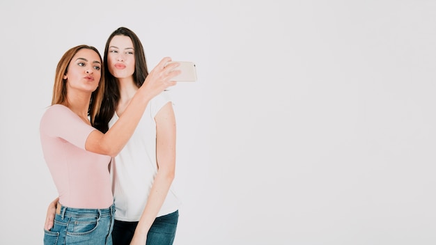 Two women taking selfie in studio
