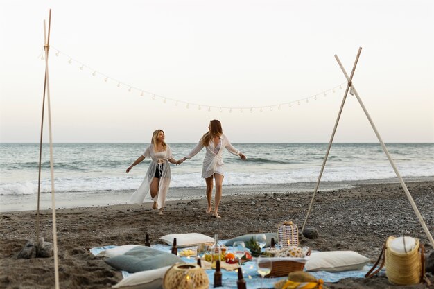 Two women together at a beach party