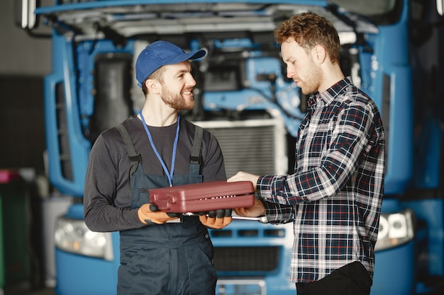 Two workers in uniform. Workers with tools. Working day