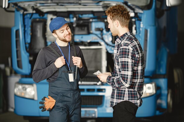 Two workers in uniform. Workers with tools. Working day.