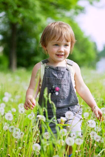 Two-year child in dandelions