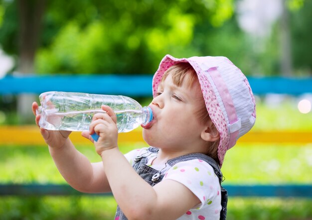 two-year child drinks from  bottle