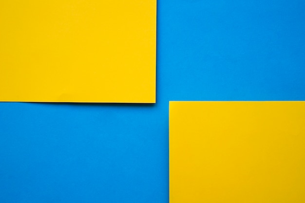 Two yellow cardboard papers on blue background