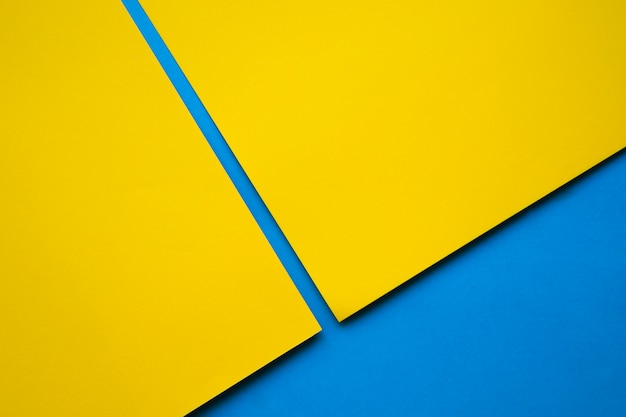 Free photo two yellow craftpapers on blue surface