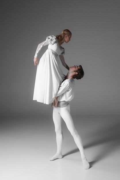 Two young ballet dancers practicing. attractive dancing performers  in white